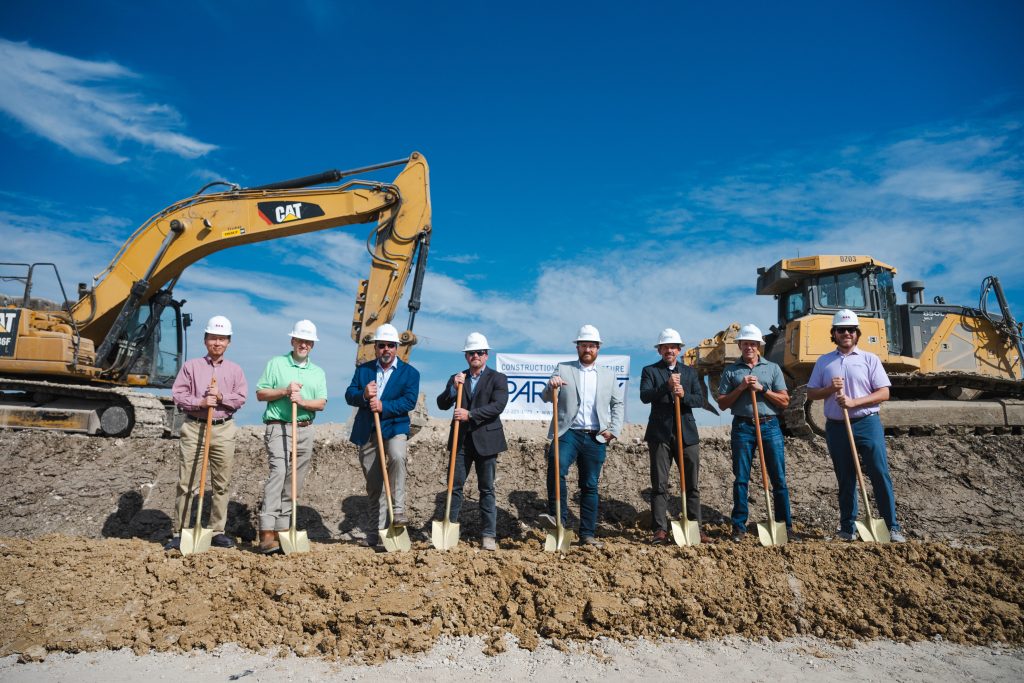 Construction reviewing plans with commercial contractor on jobsite